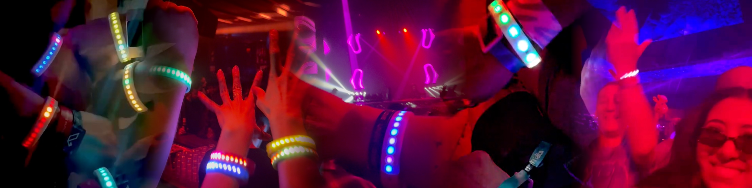 LumiBand LED wristbands illuminating a crowd at a live concert