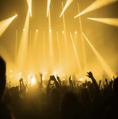 Concert crowd with synchronized light beams and glowing wristbands